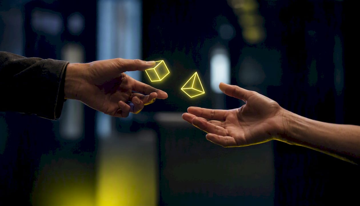 Hands exchanging glowing digital asset cubes