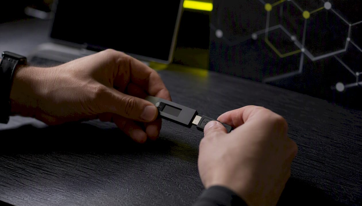Hands connecting hardware wallet and USB token