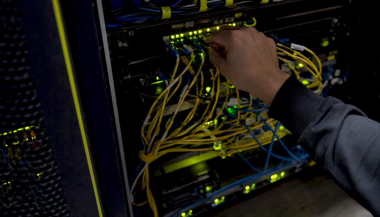 Hand adjusting network hardware in server room