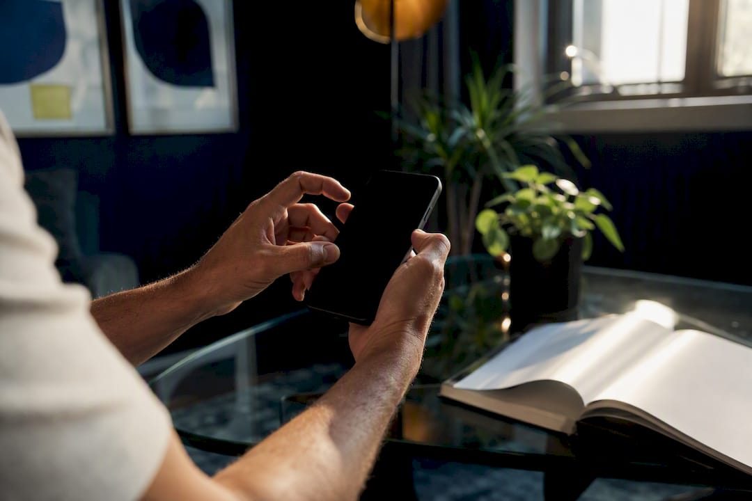 Hands holding phone ready to capture data