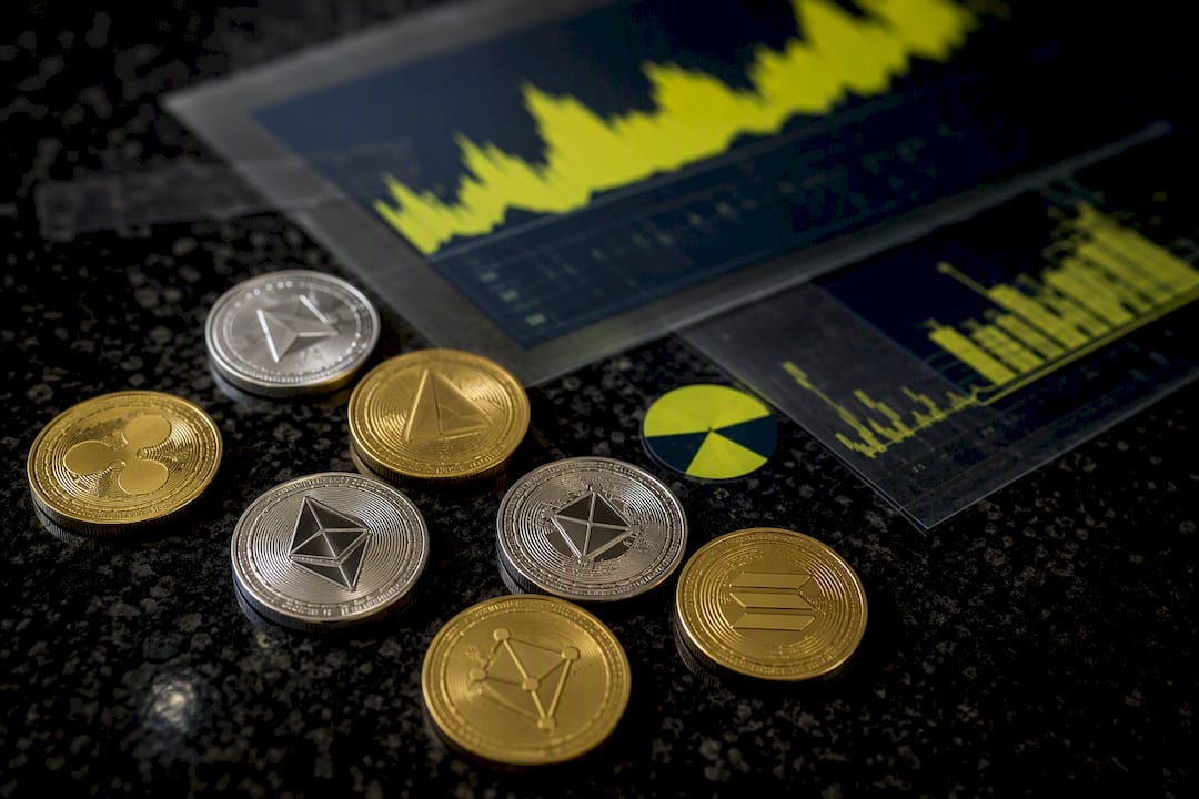 Altcoin tokens on textured fabric with charts